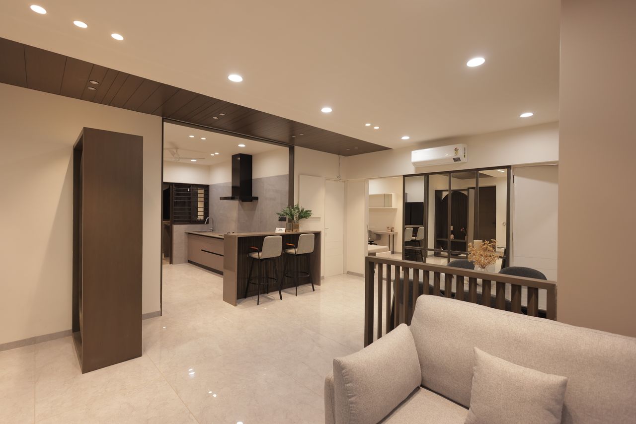 Spacious modern living room with open kitchen, showcasing minimalist design and neutral tones.
