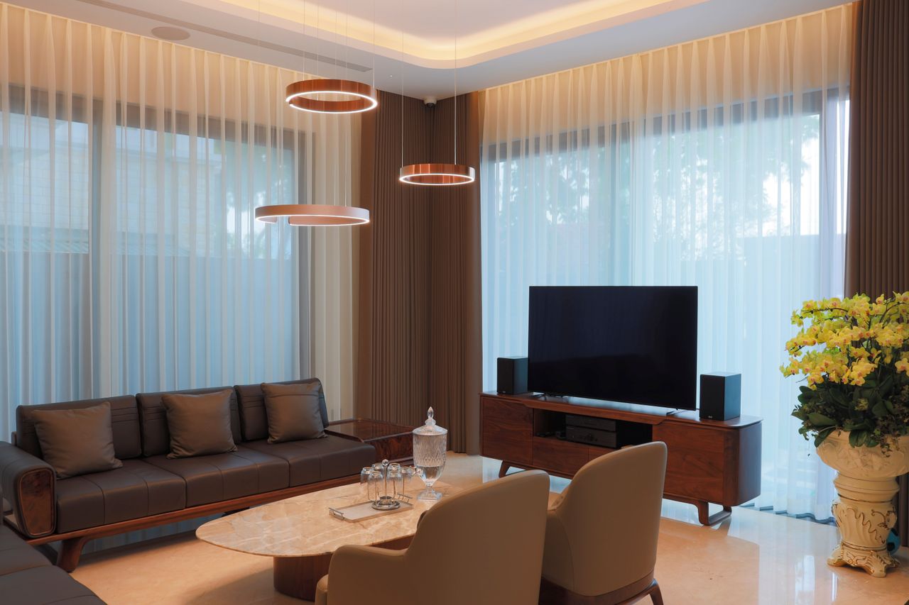 Offerings Elegant modern living room featuring stylish furniture and minimalist decor with warm lighting.